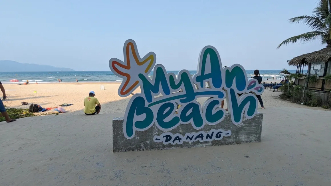The My An Beach sign on the sand in Da Nang. Living in Da Nang means a beach like this is a short walk away