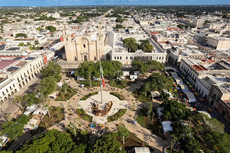 An aerial view of Mérida’s Plaza Grande and the Catedral de San Ildefonso, the historic center’s grid of streets stretching beyond.