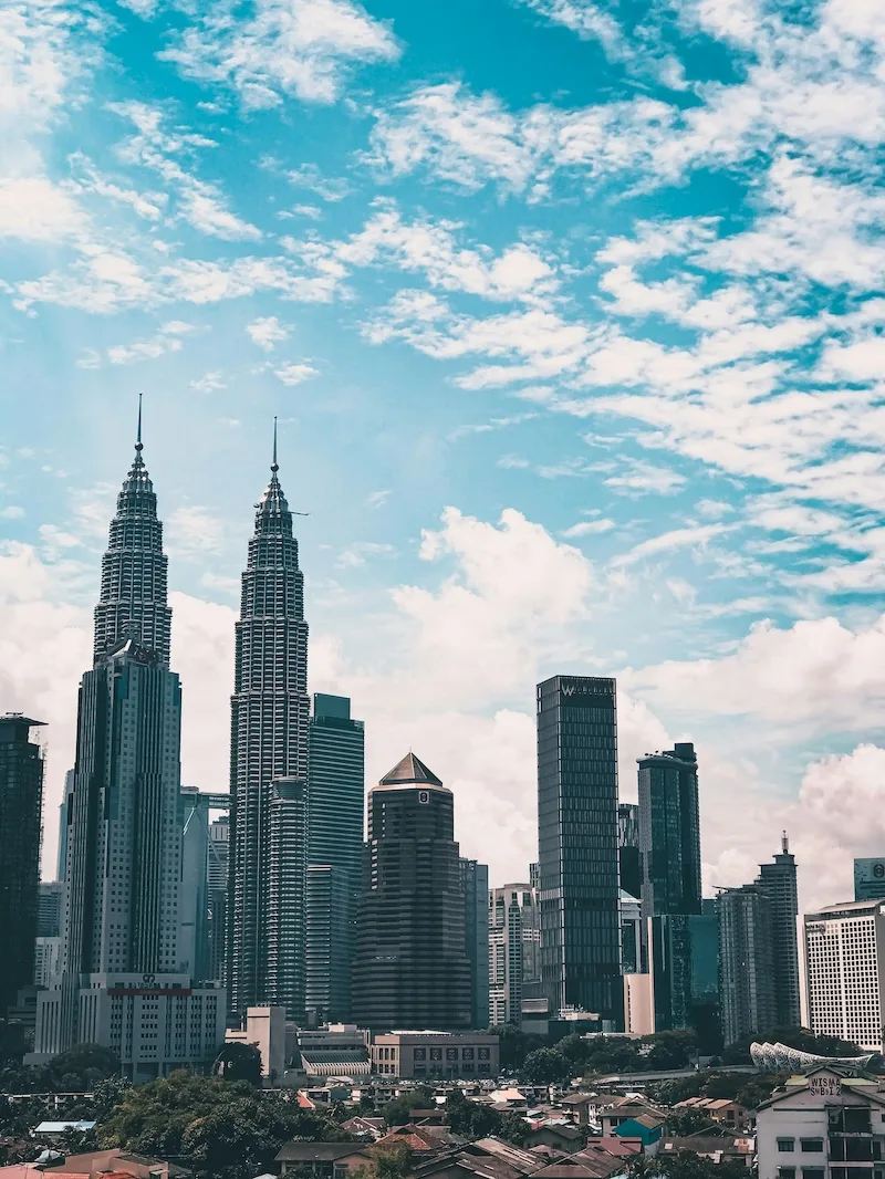 The Petronas Twin Towers rising above the Kuala Lumpur skyline.