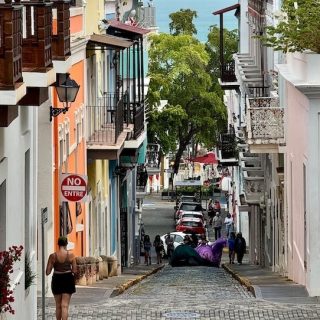 Colorful colonial street in Old San Juan, Puerto Rico, sloping down to the sea
