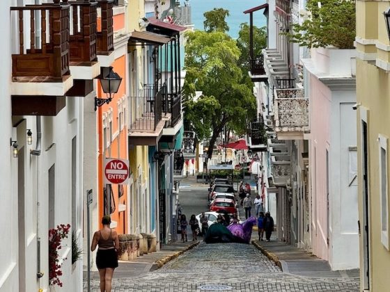 Colorful colonial street in Old San Juan, Puerto Rico, sloping down to the sea