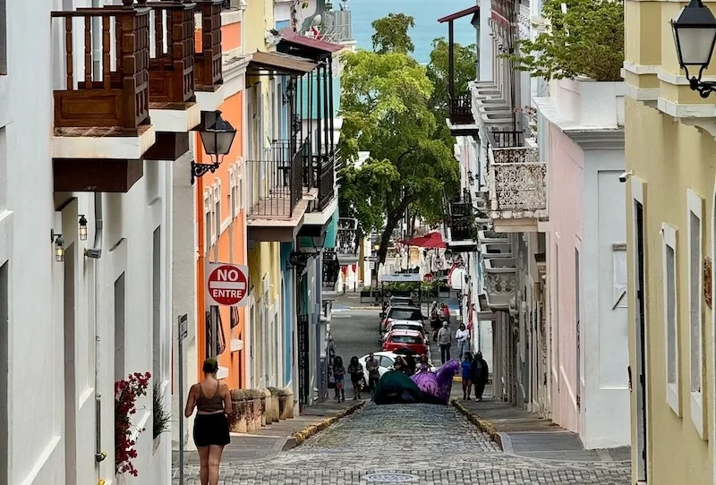 Colorful colonial street in Old San Juan, Puerto Rico, sloping down to the sea