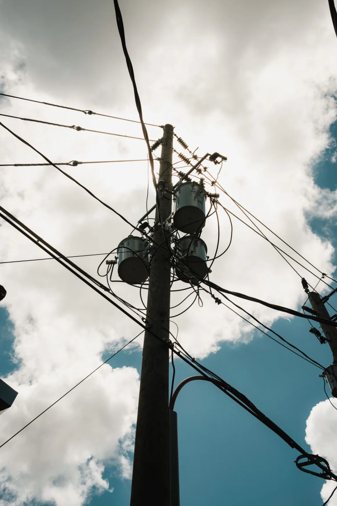 Power pole and wires against a cloudy sky, Puerto Rico electricity grid