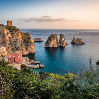 The old tuna fishery and sea stacks at Scopello, Sicily. Italy is one of the countries that pay you to move, through one-euro homes and village grants.