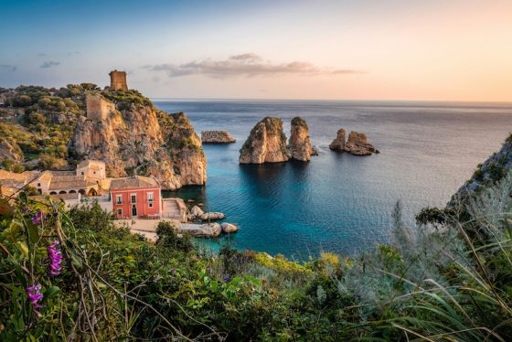 The old tuna fishery and sea stacks at Scopello, Sicily. Italy is one of the countries that pay you to move, through one-euro homes and village grants.