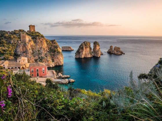 The old tuna fishery and sea stacks at Scopello, Sicily. Italy is one of the countries that pay you to move, through one-euro homes and village grants.
