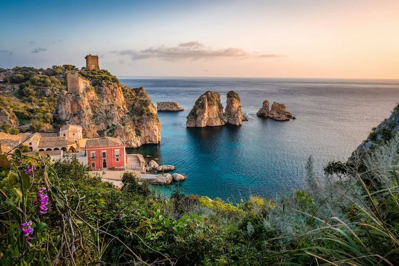 The old tuna fishery and sea stacks at Scopello, Sicily. Italy is one of the countries that pay you to move, through one-euro homes and village grants.